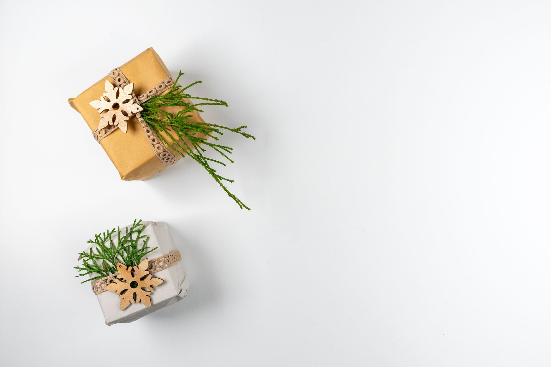 Flat lay of elegantly wrapped holiday gifts on white background.